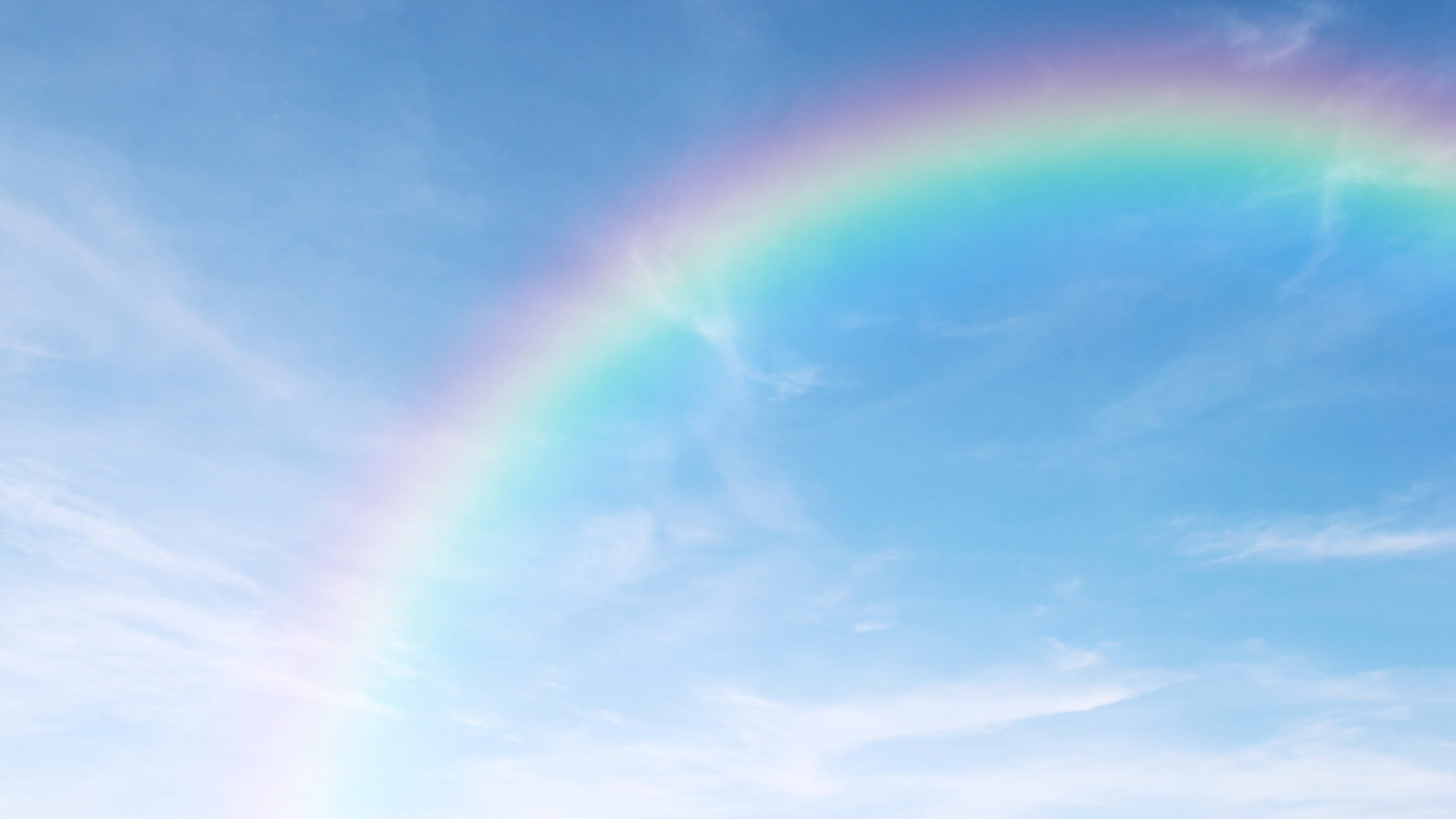 Rainbow across a blue sky