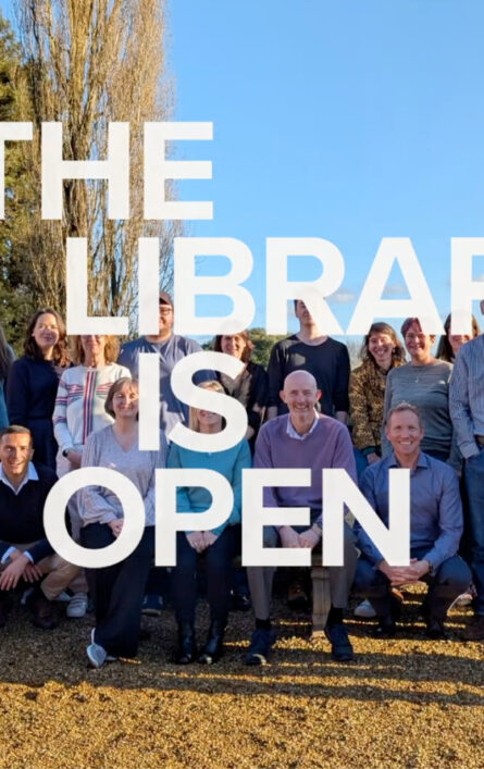 Text 'The library is open' overlaying a photo of the Open Fifth team.